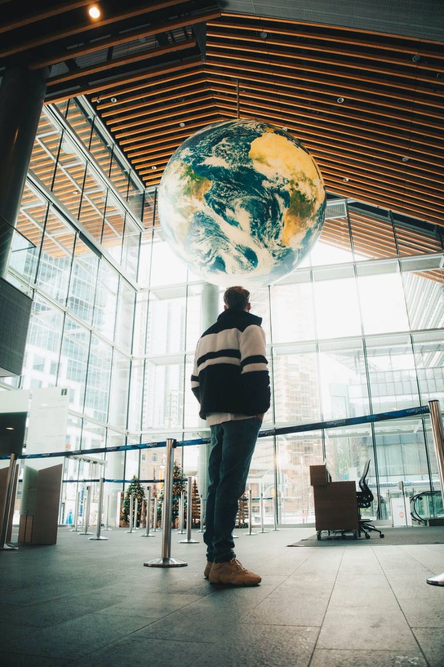 A young male entrepreneur looking at a world globe in an office.
