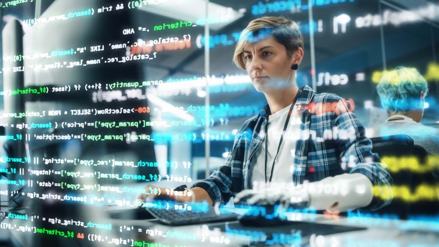 A female programmer working on a data protection code with code lines overlaid over her.