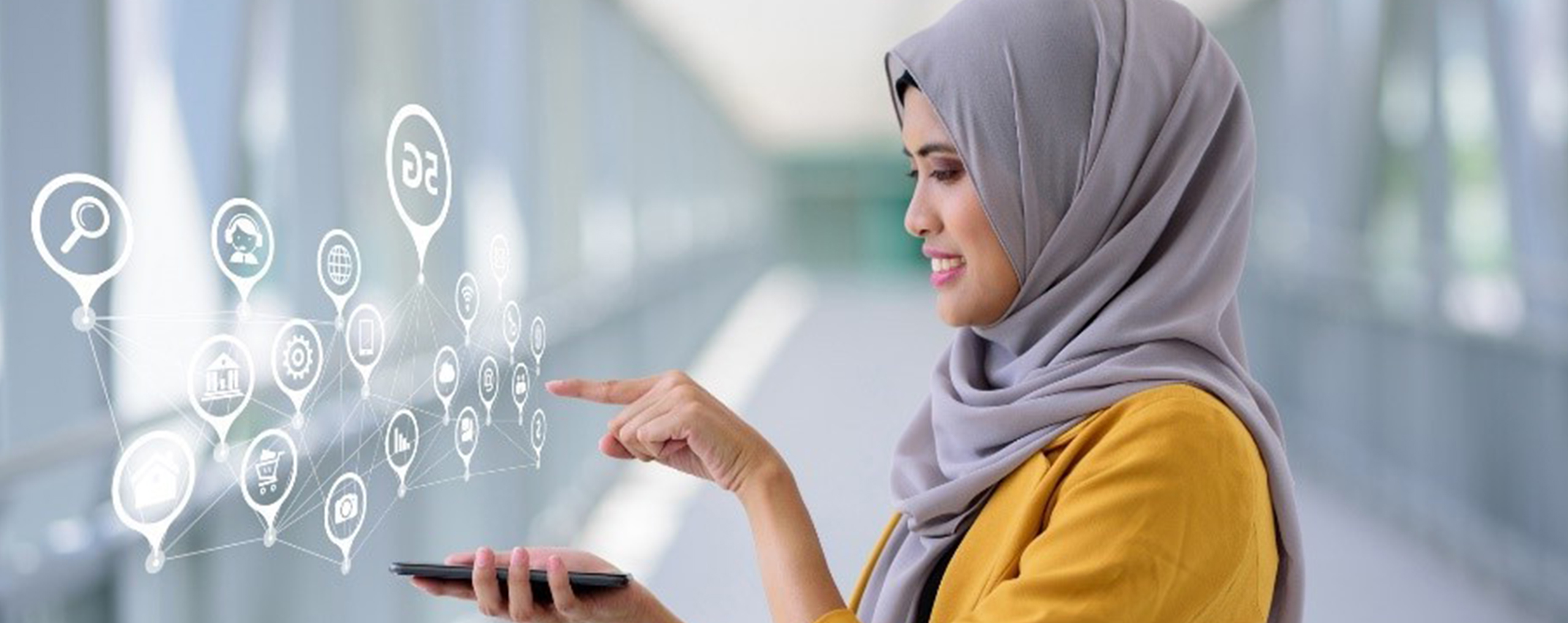 A woman in a hijab selecting icons floating above a smartphone.